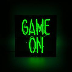 a green neon sign that says game on