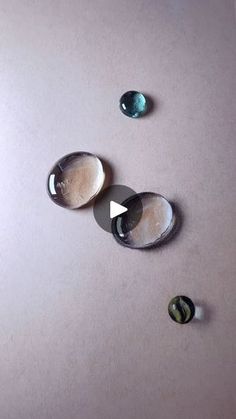 three different colored stones sitting on top of a table