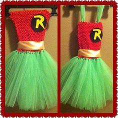 a green and red crocheted dress hanging on a wall