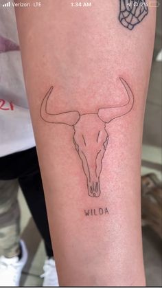 a tattoo on the arm of a woman with a bull's head and name