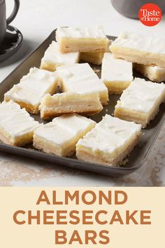 almond cheesecake bars on a baking sheet with coffee in the background and text overlay that reads, almond cheesecake bars