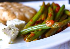 asparagus, bread and sauce on a white plate