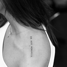 the back of a woman's neck with an inscription on it