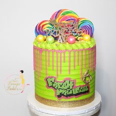 a birthday cake decorated with candy and lollipops