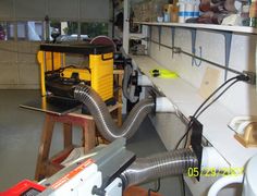 there are many different tools on the shelves in this garage, including a blow dryer