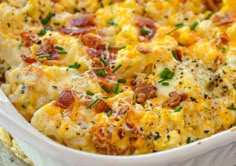 a casserole dish with bacon, cheese and chives