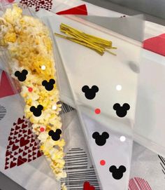 a mickey mouse treat bag with popcorn in it and some ears on the top of it