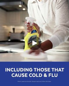 a woman is cleaning the counter top with a yellow spray bottle and white cloth on it