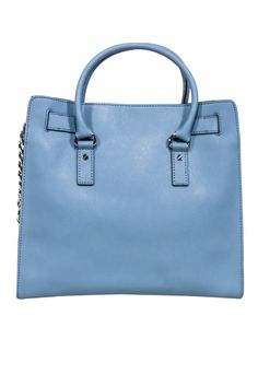 The classic tote gets a modern update with striking details by Michael Kors. A chunky monogrammed padlock and combination chain and leather shoulder strap add an edgy twist to this timeless accessory. Crafted in a beautiful baby blue, this tote bag is the perfect pop of color to compliment your office wardrobe. Leather Silver toned hardware Center magnetic snap closure Interior zipper pocket Four interior open pockets Double handle Extended chain strap Width 14" Height 13.5" Depth 4.5" Handle dr Blue Satchel With Palladium Hardware, Blue Satchel Shoulder Bag With Palladium Hardware, Trendy Travel Bag With Palladium Hardware, Blue Top Handle Satchel With Silver-tone Hardware, Blue Shoulder Bag With Palladium Hardware For Office, Modern Satchel With Chain Strap For Shopping, Blue Rectangular Satchel With Palladium Hardware, Blue Office Satchel With Branded Hardware, Chic Michael Kors Satchel For On-the-go