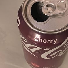 a can of cherry soda on a white table