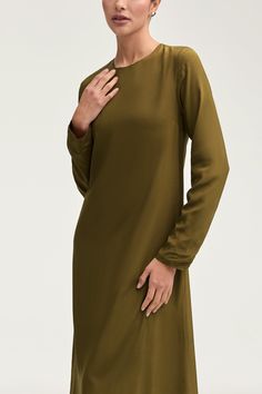 Indulge in luxury with the Estee Viscose Maxi Dress in Olive Night. Crafted with breezy viscose material, this dress boasts a modest fit and straight sleeves perfect for the summer. Dress it up or down and enjoy the ultimate comfort and effortless style no matter the occasion. Elevate your wardrobe with this exquisite piece. Model is 5'7" and is wearing size XS/58". Green Long Sleeve Viscose Dress, Elegant Viscose Mini Dress For Daywear, Flowy Viscose Mini Dress For Daywear, Chic Green Silk Long Sleeve Dress, Elegant Tunic Mini Dress For Daywear, Solid Viscose Dress For Workwear, Chic Green Long Sleeve Silk Dress, Chic Long Sleeve Green Silk Dress, Elegant Green Viscose Mini Dress