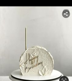 a white cake sitting on top of a plate