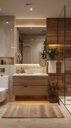 a bathroom with a toilet, sink and bathtub next to a plant in a vase