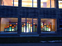 a building that has stained glass windows on the front and side of it at night