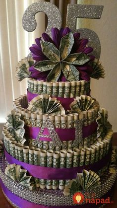 a cake made out of money with the number five on top and purple ribbon around it