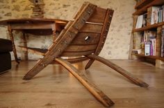 a wooden rocking chair sitting on top of a hard wood floor next to a book shelf