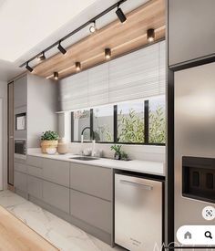 a modern kitchen with stainless steel appliances and white counter tops is featured in an appliance ad