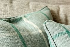 a close up view of a green and white checkered pillow