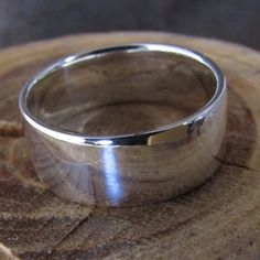 This ring makes a great man's wedding band, as it is low-profile and durable. It is made of argentium sterling silver, so it has a higher silver content than regular sterling and is age-hardened (heated in my kiln to make the ring almost as hard as gold). It is 8mm wide and 1mm thick.The band is comfort-fitted (convex shape on the inside) making it super comfortable and is casted, so there is no solder joint.The same ring is available in a brush-finish here:https://www.etsy.com/listing/150551875 Classic Sterling Silver Bands With Polished Finish, Classic Silver Bands With Polished Finish, Classic Sterling Silver Open Band Wedding Ring, Classic Sterling Silver Open Band Ring, Classic Sterling Silver Wedding Ring With Open Band, Silver Wide Band With Polished Finish, Silver Bands With Polished Finish, Silver Bands With Polished Finish And Round Cut, Classic Sterling Silver Wide Band