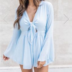 *Never Worn - Brand New Out Of The Packaging, Not In Original Packaging* This Romper Will Be Your New Weekend Favorite! We Love The Classic Light Blue Color With A Tie Front Detail. This Romper Also Features Bell Sleeves It's Such A Cute Detail. Pair It With Wedges And A Floppy Sun Hat For Your Next Beach Getaway! Flowy Romper Style Wears Like A Dress With Shorts - 100% Rayon - Lining 100% Polyester - Hand Wash Cold / Dry Flat Dress With Shorts, Floppy Sun Hat, Flowy Romper, Floppy Sun Hats, Loving Heart, Beach Getaway, Pink Lily, Light Blue Color, Dress Romper