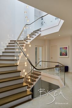 a stair case with lights on it in a house