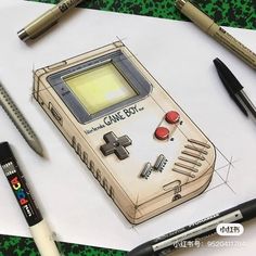 a drawing of an old school gameboy next to some pens and crayons