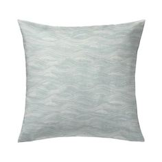 a white pillow with waves on the front and back, sitting on a white background