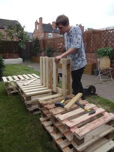 a man is working on some wood in the yard