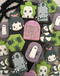 decorated cookies are arranged in the shape of tombstones and ghost faces on a table