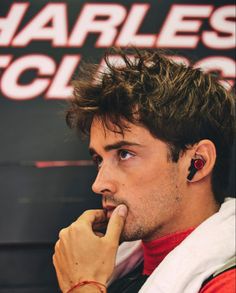 a close up of a person with ear buds in his ears and wearing a watch