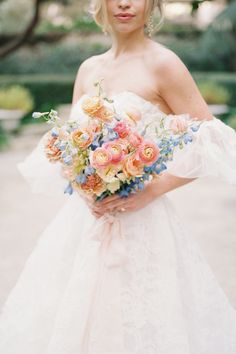 a woman in a wedding dress holding a bouquet