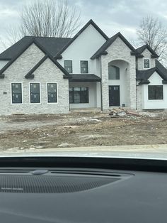 a car is parked in front of a house under construction