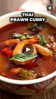 thai prawn curry in a bowl on a table with the words thai prawn curry above it