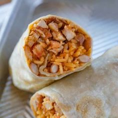 two burritos with meat and cheese on them