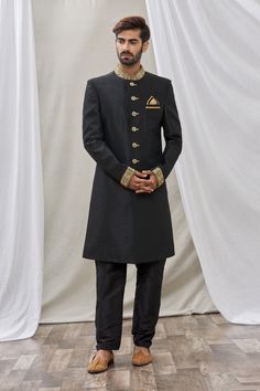 Black sherwani with patch pocket and embroidered mandarin collar. Paired with pant.
Component: 2
Pattern: Embroidered
Neckline: Mandarin
Sleeve Type: Full Sleeves
Fabric: Art Banarasi Silk, Dupion Art Silk
Color: Black
Other Details: 
Front buttons
Note: Pocket square worn by the model is not for sale
Occasion: Sangeet - Aza Fashions Ceremonial Black Sherwani With Cutdana, Black Sherwani With Naqshi For Festivals, Ceremonial Black Kurta With Naqshi Detailing, Ceremonial Black Kurta With Naqshi, Ceremonial Black Naqshi Traditional Wear, Black Sherwani With Pallu, Straight Kurta Style, Black Naqshi Bandhgala For Festive Occasions, Traditional Formal Churidar With Resham Embroidery, Traditional Fit Sherwani For Ceremonial Occasions