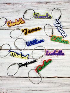 personalized name keychains on a white wooden background