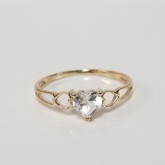 "Thanks for shopping our vintage estate store. We tend to sell well below wholesale and truly hope you enjoy all of our items. Many of the items are one of a kind, so please enjoy scrolling through the pictures and hopefully something will catch your eye. Black spots are from the camera. Beautiful estate ring 10k yellow gold natural white .25ct topaz heart sweetheart or birthstone ring. Gem is testing natural. Last pictures shows others that we have listed. Ring size: 6 Setting: 5.5mm 1/4\" Band Classic 14k Gold Heart-shaped Birthstone Ring, Vintage Gold Topaz Birthstone Ring, Classic 14k Gold Heart Ring With Gemstone, Classic Heart Ring With Birthstone For Anniversary, Vintage Gold Heart Ring With Birthstone, Vintage Heart Ring With Birthstone, Vintage Topaz Birthstone Ring For Anniversary, Classic Heart-shaped Birthstone Ring For Anniversary, Vintage 14k Gold Heart Cut Jewelry