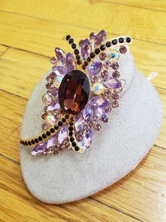 "1950s, 4\" long and 2\" wide, amethyst glass and pink rhinestone ornate brooch ,with gold tone molded back. Condition excellent Price $ 85" Purple Brooch Jewelry For Evening, Purple Amethyst Brooches For Wedding, Elegant Purple Rhinestone Brooches, Purple Rhinestone Party Brooches, Feb 8, Pink Rhinestones, Brooch Pin, Brooches, Gold Tones