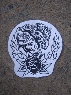 a sticker with an image of two horses in the middle of flowers on it