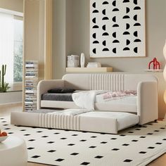 a living room with a white couch and black and white rug