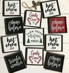 six framed christmas signs hanging on a wall