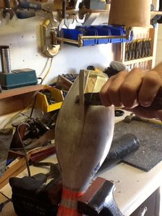 a man is working on an object in his workshop