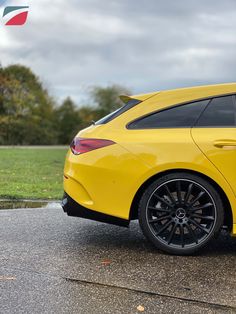 a yellow sports car is parked on the street