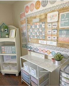 a desk with lots of cards on the wall next to a bookcase and shelf