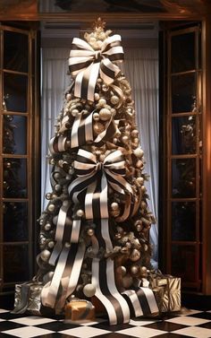 a decorated christmas tree with black and white ribbons