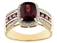 Park Avenue Collection® 2.66ct 9x7mm rectangular cushion cut rhodolite garnet center stone surrounded by 0.74ctw 2.50mm square rhodolite garnet and 0.26ctw round white diamond, 14k yellow gold halo ring. Measures approximately 3/8"L x 7/16"W and is sizeable. White rhodium enhanced prongs around the white diamonds. Gold Halo Ring, Rectangular Cushion, Gold Halo, Rhodolite Garnet, Park Avenue, Halo Ring, Halo Rings, White Diamonds, Cushion Cut