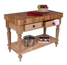 a wooden table with two drawers and a bowl of fruit on the top, next to a cookbook