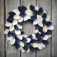 a wreath made out of felt with blue and white flowers