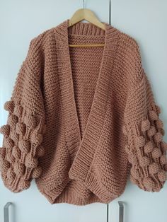 "Hand knitted chunky buble sleeve cardigan. The yarn is high quality and very soft, 25% wool 75% acrylic. Headband of the same colour is given as a gift. Two sizes are available. S -XS size is shown in the photo. S-XS Width 48 cm (19\") Lenght 53 cm (21\") Sleeve 43 cm ((17\") M-L Width 56 cm (22\") Lenght 60 cm (24\") Sleeve 43 cm (17\") Care Instructions: - Wash at 30o - Do not tumble dry - Do not iron Shipping: This item is made to order. It will be dispatched 5-6 days after the order is plac Trendy Chunky Knit Sweater With Balloon Sleeves, Cozy Balloon Sleeve Sweater, Cozy Textured Knit Cardigan, Chunky Knit Puff Sleeve Sweater For Fall, Cozy Textured Knit Acrylic Cardigan, Fall Chunky Knit Sweater With Puff Sleeves, Cozy Textured Knit Puff Sleeve Sweater, Cozy Textured Knit Sweater With Puff Sleeves, Cozy Knit Sweater With Puff Sleeves