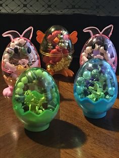 three small plastic toys sitting on top of a wooden table